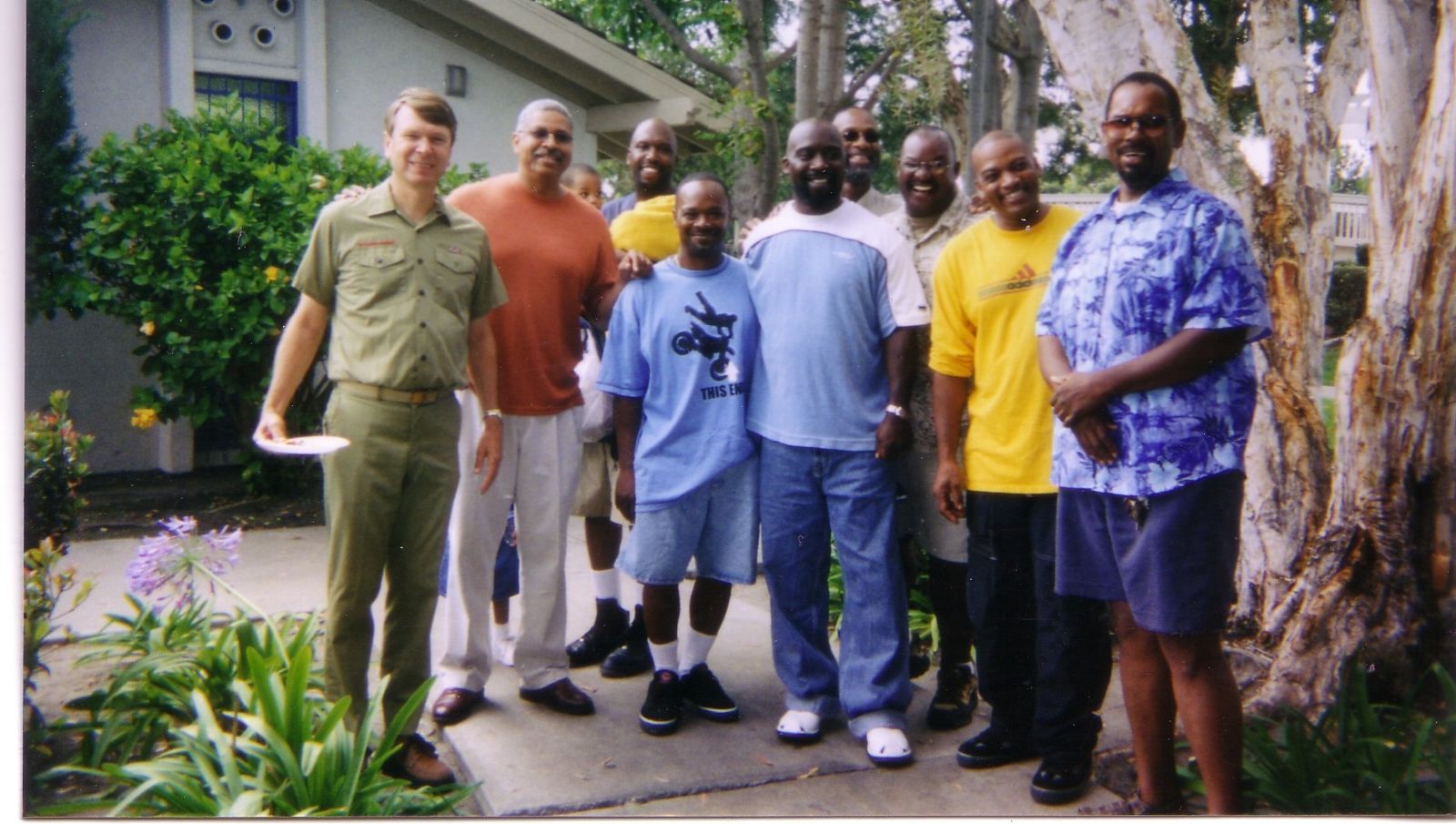 Steve Hauser standing with former scouts, now grown men