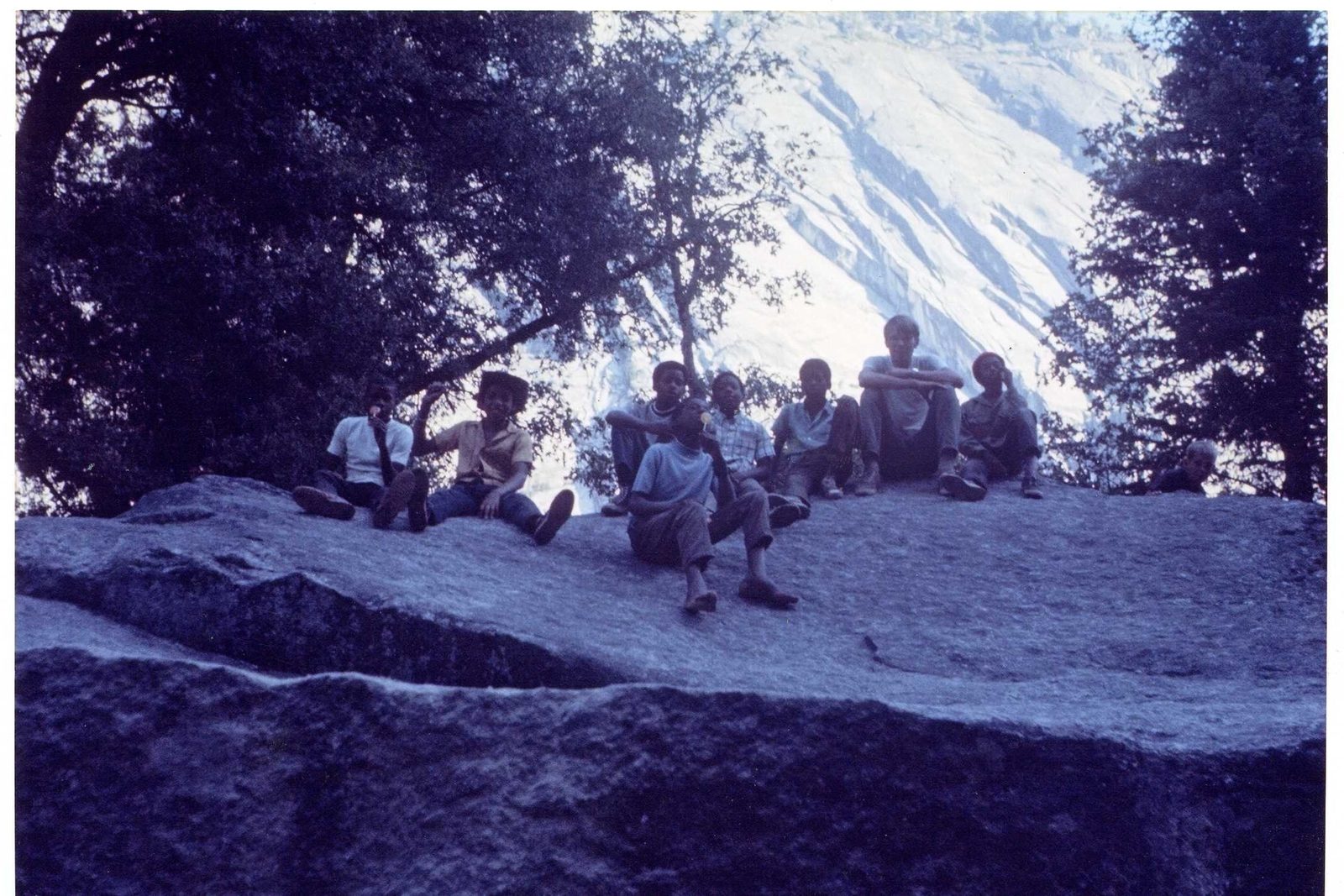 Steve Hauser with scouts among boulders and pines in Yosemite